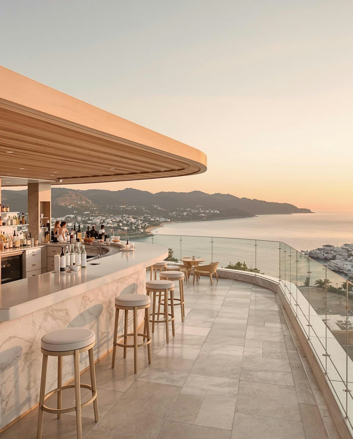 Rooftop cocktail bar with marble counter and coastal view at sunset
