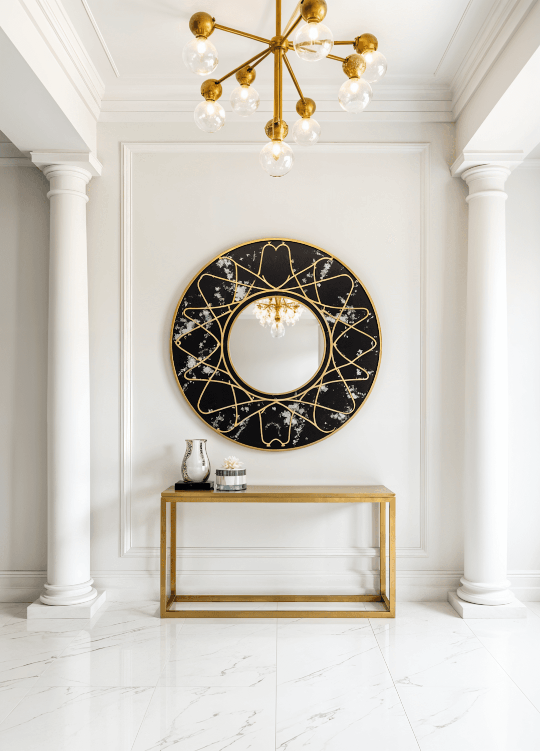 The marble atrium of the Mangol Royale, lit by a chandelier above a gold-framed console